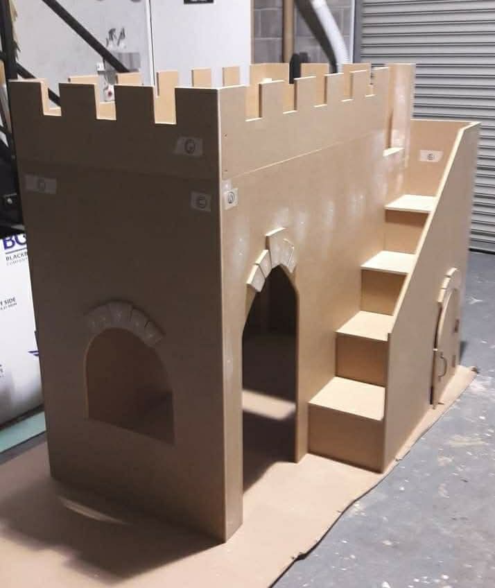 Castle-shaped children's bed with a staircase, built from board