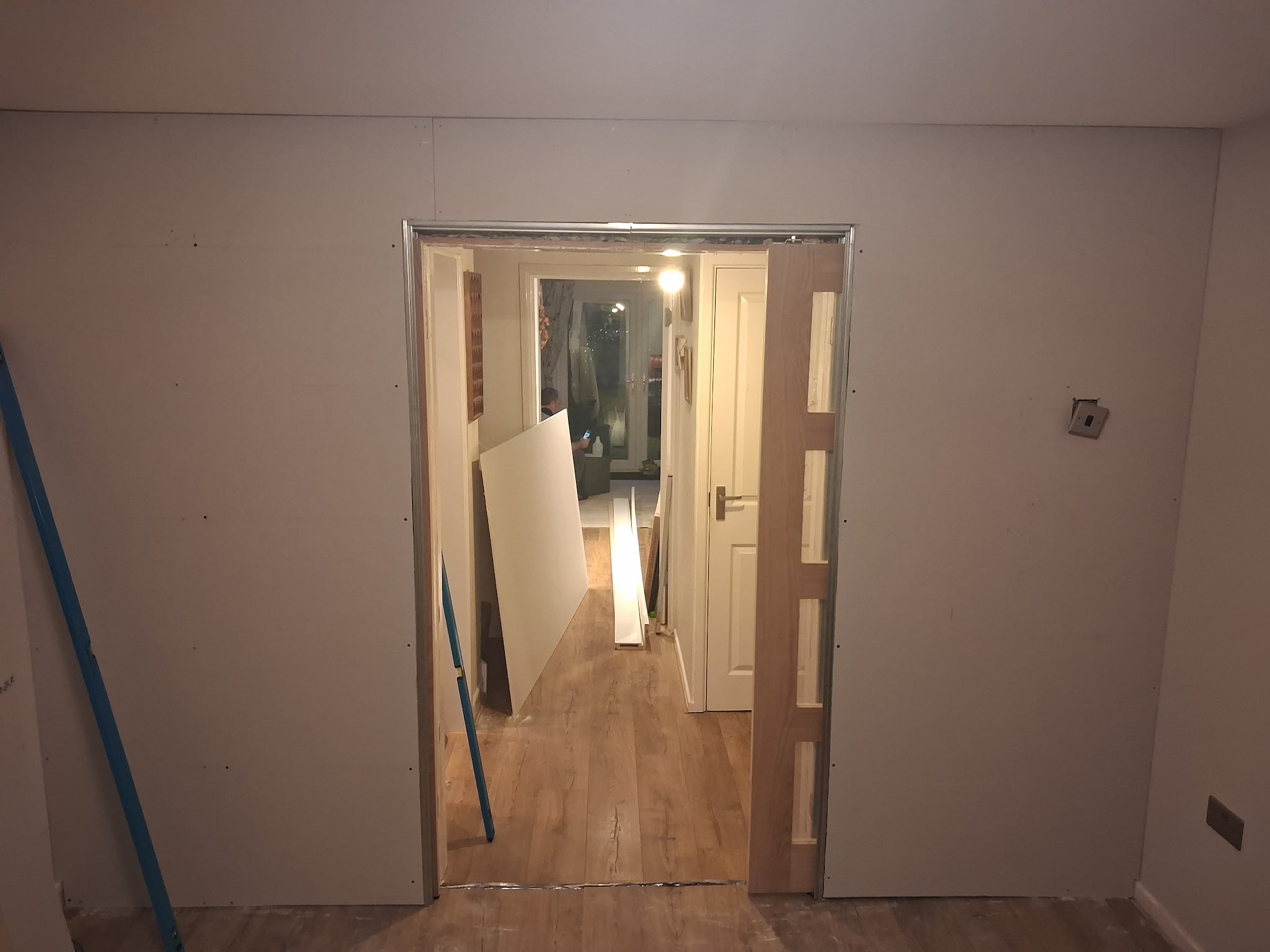 New plasterboard wall with a framed doorway through to the hallway